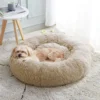 A serene dog enjoys the comforting embrace of a brown Plush Shag Pet Bed, epitomizing pet relaxation