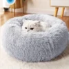 Fluffy white cat enjoying the supreme comfort of a luxurious grey Plush Shag Pet Bed, blending seamlessly into a cozy home setting